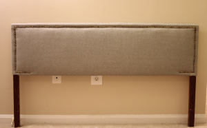 Looking to change up your headboard? Take a look at this awesome DIY Upholstered Headboard with Nailhead Trim! UpcycledTreasures.com