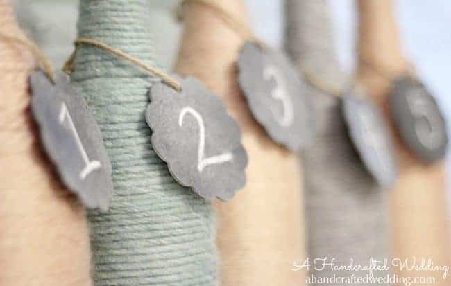 Check out how to upcycle bottles into Yarn Wrapped Bottle Vases or Table Numbers for your Wedding Reception Decor | MountainModernLife.com