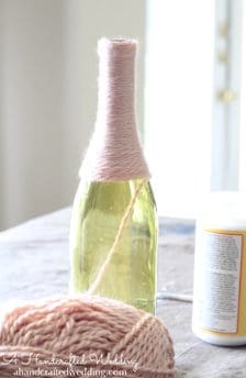 Check out how to upcycle bottles into Yarn Wrapped Bottle Vases or Table Numbers for your Wedding Reception Decor | MountainModernLife.com