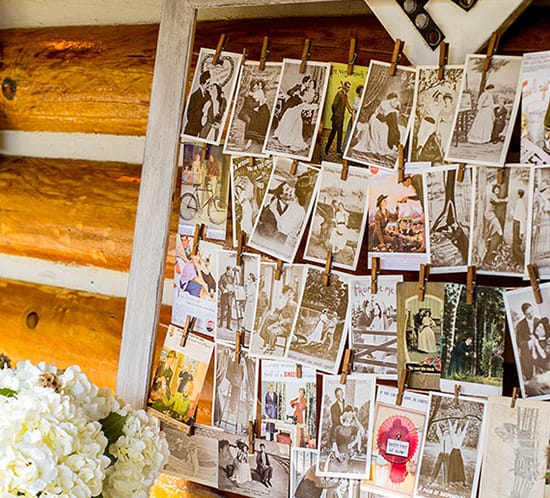 DIY Yarn Clothespin Frame on guestbook table with vintage postcards ahandcraftedwedding photo mountainmodernlife.com