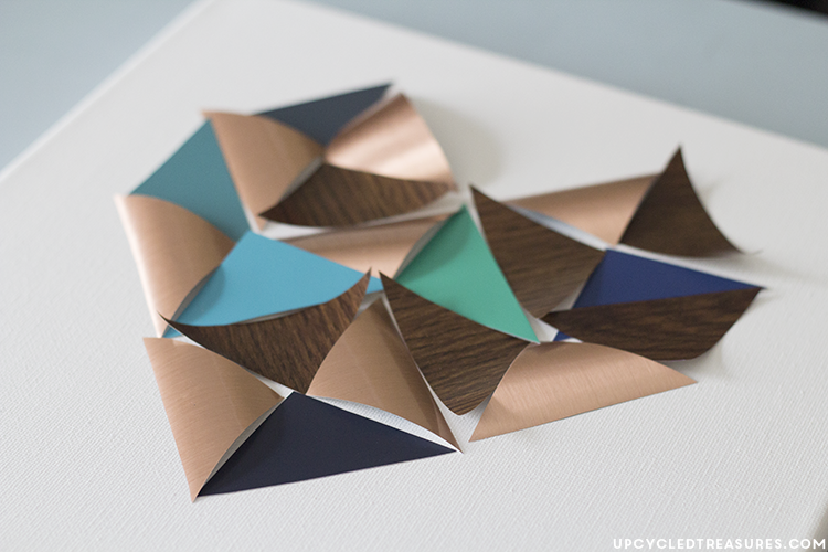 See how easy it is to create this geometric DIY heart wall art using contact paper and paint chips, perfect for Valentine's Day! MountainModernLife.com