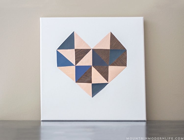 See how easy it is to create this geometric DIY heart wall art using contact paper and paint chips, perfect for Valentine's Day! MountainModernLife.com