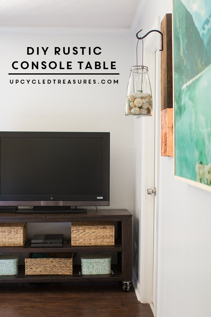 This DIY rustic console table is the perfect storage solution that doubles as a TV stand in this modern rustic bedroom. UpcycledTreasures.com