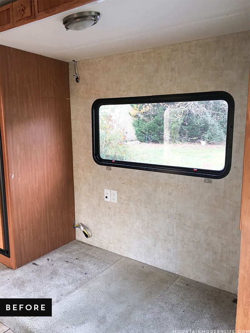RV Slide Out with boring carpet before we installed planked flooring | MountainModernLife.com
