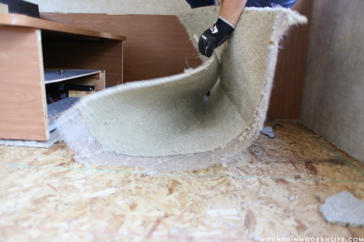 Removing the carpet inside the bedroom of the RV | MountainModernLife.com