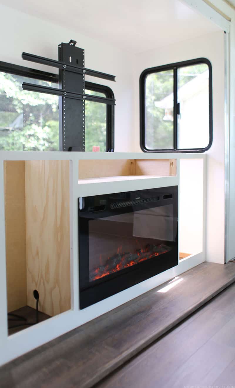 tv-lift-and-fireplace-installed-inside-custom-cabinet-mountainmodernlife.com