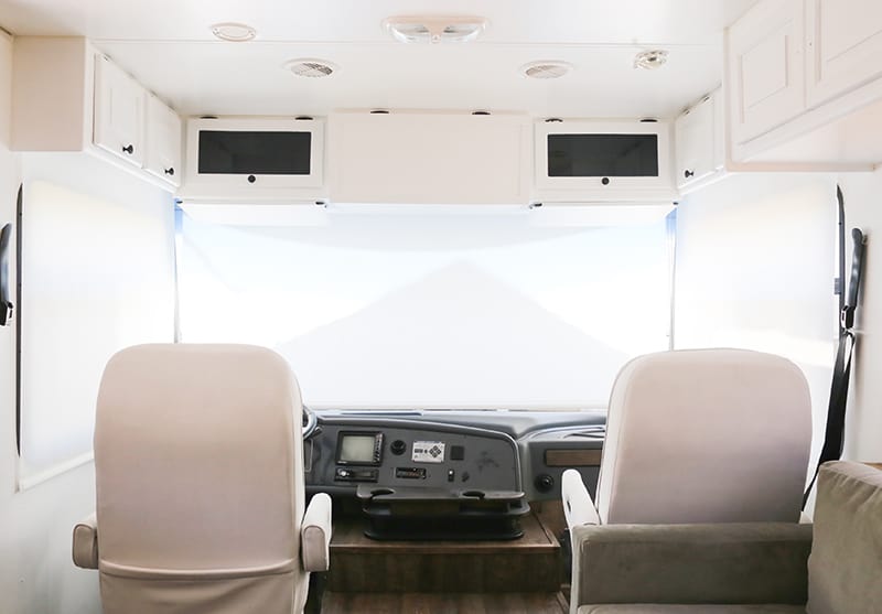 Looking to replace those bulky curtains in the front of your RV? See how easy it was for us to install our new RV windshield roller shades! MountainModernLife.com