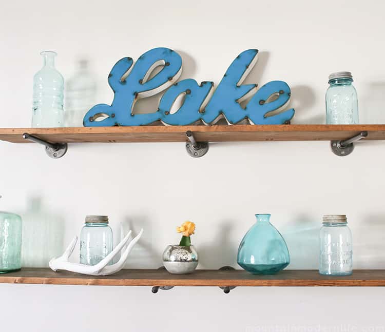 Looking to create shelves with little to no tools? See how you can easily create these Rustic Modern Shelves using pipes! MountainModernLife.com