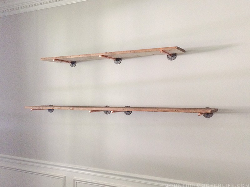 Looking to create shelves with little to no tools? See how you can easily create these Rustic Modern Shelves using pipes! MountainModernLife.com