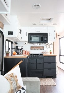 Planning to paint your tiny kitchen and considering using black? Check out these two-toned painted RV kitchen cabinets! MountainModernLife.com