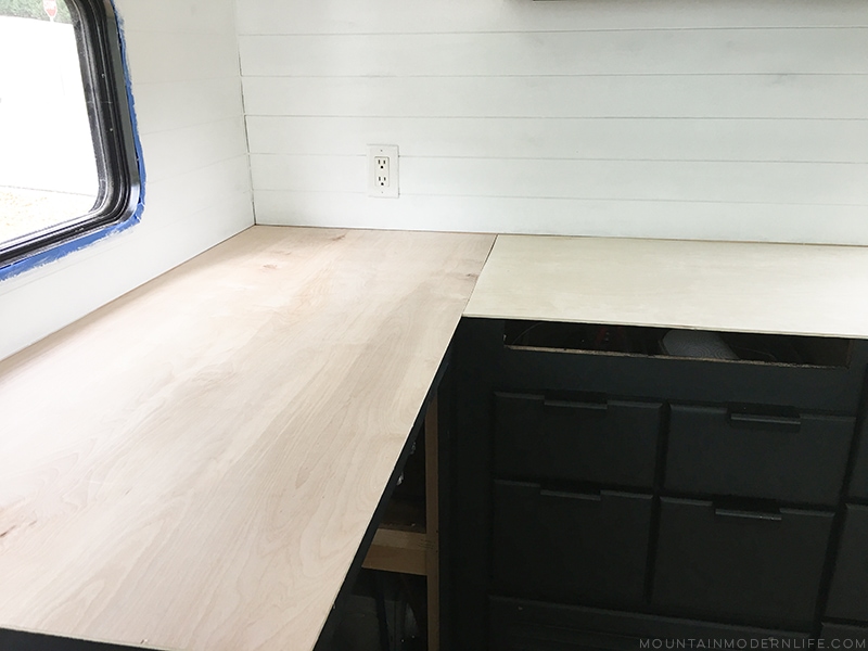 Looking for an affordable way to update your kitchen counters? Check out this post on how to Create Wood Counters from Flooring (in a RV)! MountainModernLife.com