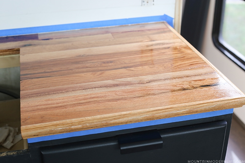 Looking for a natural wood sealer for your counters? See how we protected our RV kitchen countertops using Tung Oil which is food safe and water resistant! MountainModernLife.com
