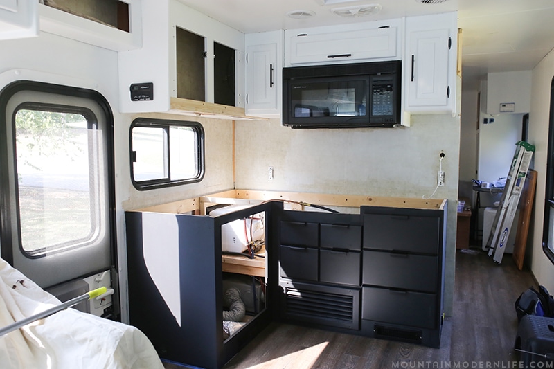 Looking for an affordable way to update your kitchen counters? Check out this post on how to Create Wood Counters from Flooring (in a RV)! MountainModernLife.com