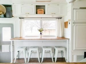 Tour this modern yet cozy renovated RV filled with lots of white, shiplap, and warm wood tones from @WilsonGrandAdventures! Featured on MountainModernLife.com