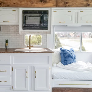 Tour this modern yet cozy renovated RV filled with lots of white, shiplap, and warm wood tones from @WilsonGrandAdventures! Featured on MountainModernLife.com
