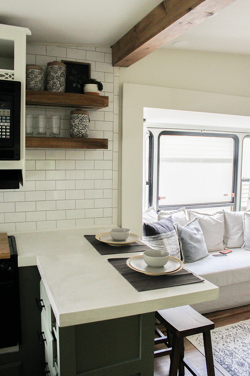 This remodeled RV has the coziest fireplace you've ever seen in a tiny home. Featuring @karleeandweston on MountainModernLife.com