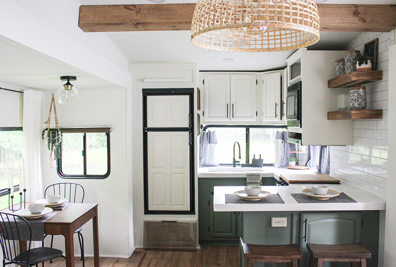 This remodeled RV kitchen has green cabinets and white concrete counters (and it's for sale!). Featuring @karleemmarsh on MountainModernLife.com