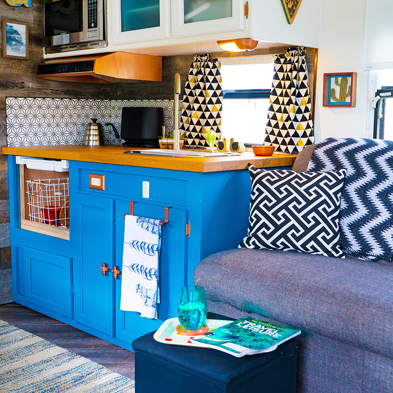 camper kitchen with blue cabinets