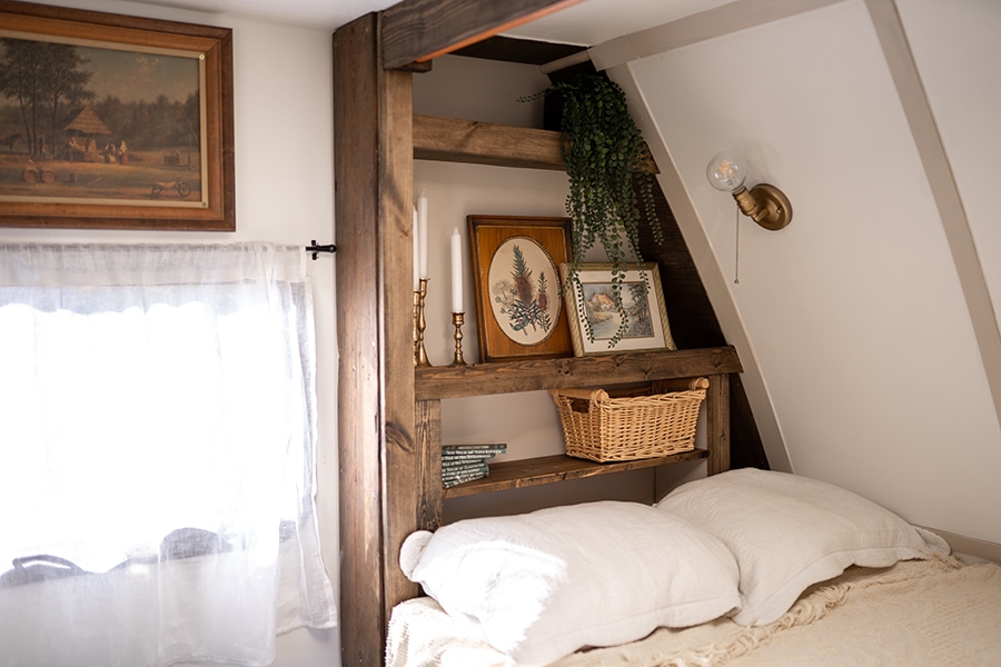 cozy vintage-inspired bed nook inside camper