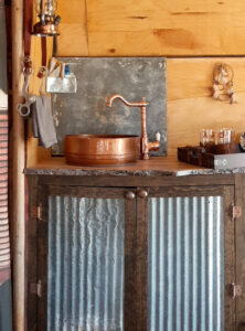 western camper kitchen with copper sink and corrugated metal