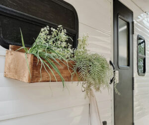 painted camper exterior with window boxes