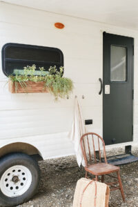 painted camper exterior with window flower boxes