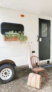 painted camper exterior with window flower boxes