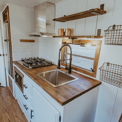 Tour this family-friendly camper remodel that includes a DIY epoxy shower