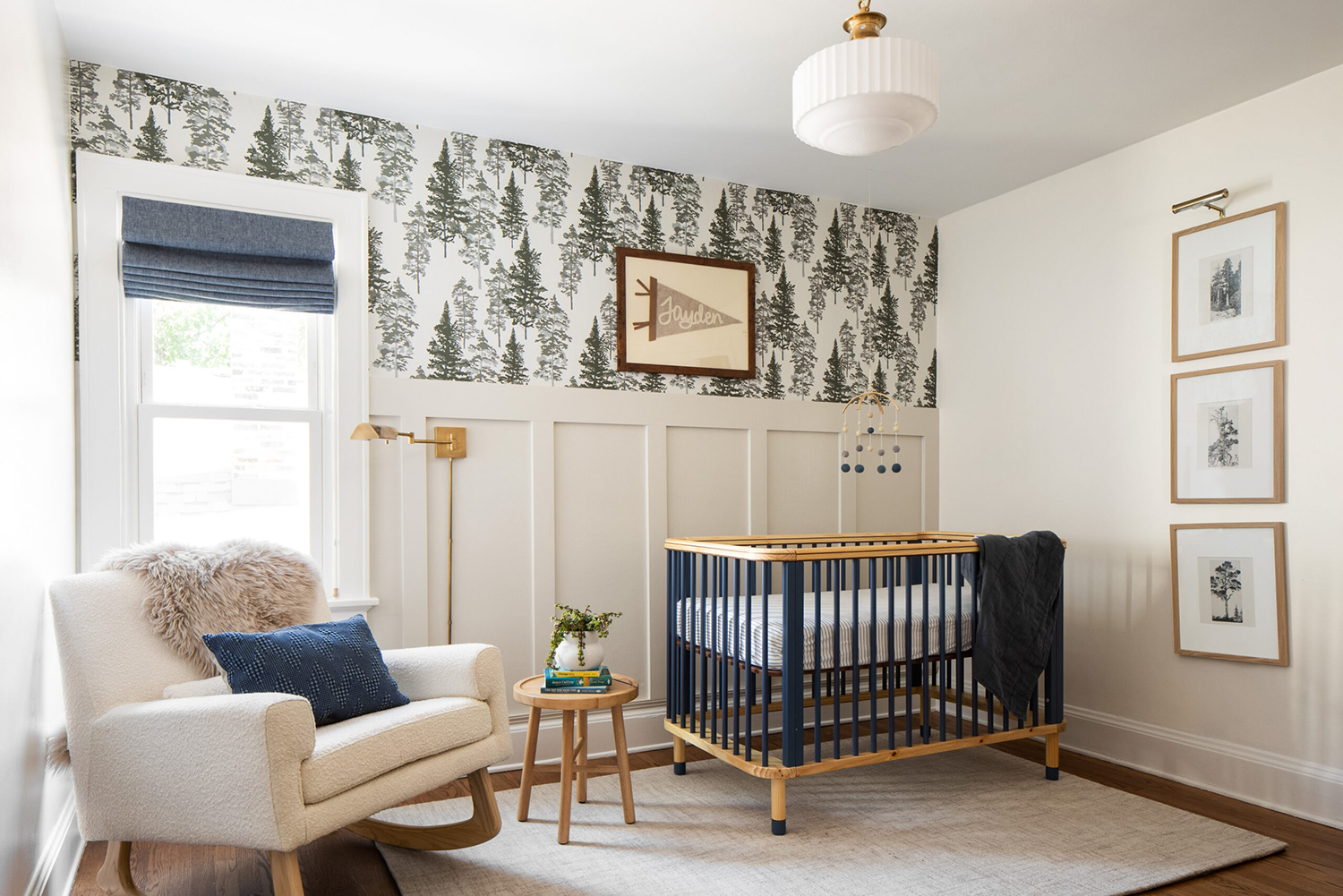 gender-neutral nursery that's rustic and refined with evergreen tree wallpaper