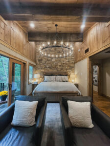 stone accent wall in mountain home bedroom