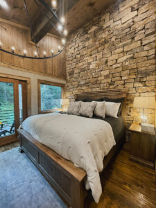 rustic modern bedroom with stone wall from Blue Ridge Mountains Parade of Homes